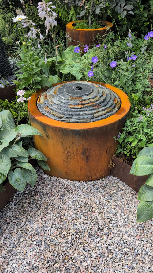 Zoom in video to show a close up of the water feature flowing and the relaxing sound.